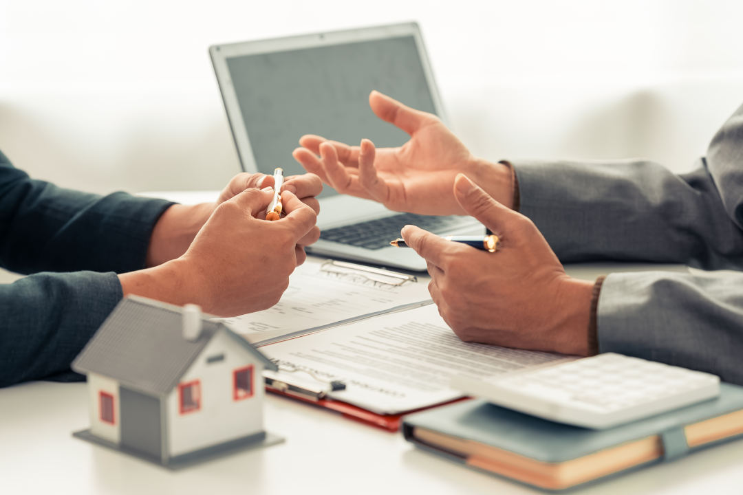 The real estate agent discussed the terms of the home purchase contract and asked the client to sign the document to legally complete the contract.